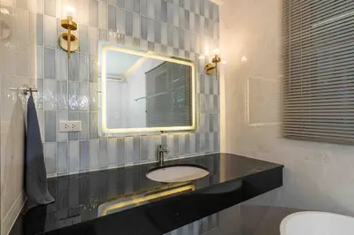 a bathroom with a sink and a mirror at Private 4BR Model Home center Patong in Patong Beach