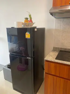 a refrigerator in a kitchen with a bowl on top of it at Heavenly place 777 on Mai Khao in Ban Mai Salae