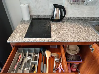 a kitchen counter with a drawer filled with utensils at Heavenly place 777 on Mai Khao in Ban Mai Salae