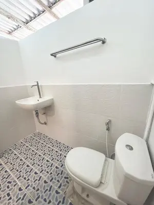 a bathroom with a white toilet and a sink at Modern Sunset Sea House Lam Sai in Ko Yao Noi