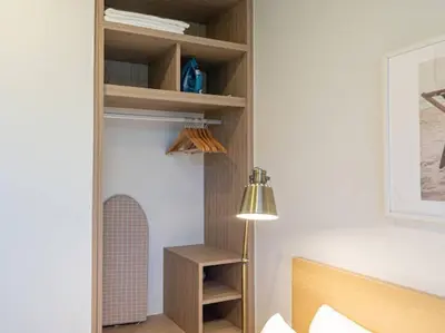 a room with a bed and a lamp and shelves at Bangtao , Laguna , 5 minutes from the bench, 2 bedroom in Ban Thalat Choeng Thale