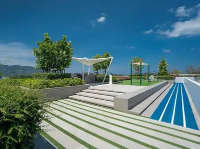 a swimming pool with stairs and a blue swimming pool at Bangtao , Laguna , 5 minutes from the bench, 2 bedroom in Ban Thalat Choeng Thale