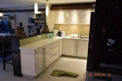 a kitchen with white cabinets and a counter top at KALIM RESIDENCE UNIT 133 VUE MER in Patong Beach