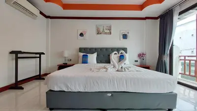 a bedroom with a bed with two swans on it at Benetti house in Patong Beach