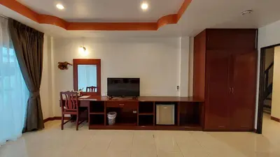a living room with a desk with a television at Benetti house in Patong Beach