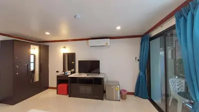 a room with a kitchen with a stove and a window at Benetti house in Patong Beach