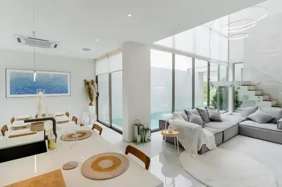 a living room with a couch and a table at The Residence by Andaman Phuket in Ban Mut Dok Khao