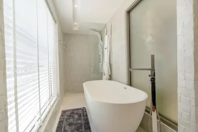 a bathroom with a white toilet and a window at The Residence by Andaman Phuket in Ban Mut Dok Khao