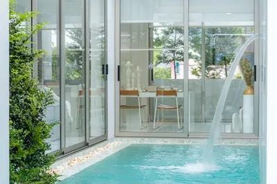 a swimming pool with a fountain in a house at The Residence by Andaman Phuket in Ban Mut Dok Khao