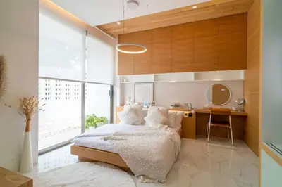 a bedroom with a bed and a desk in it at The Residence by Andaman Phuket in Ban Mut Dok Khao
