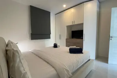 a bedroom with a large bed and a television at Karon Butterfly Condominium Brandnew 68m2 apartment, seaview, pool access, 500m to beach in Karon Beach