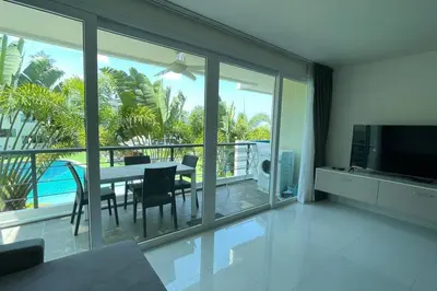 a dining room with a table and a view of the ocean at Karon Butterfly Condominium Brandnew 68m2 apartment, seaview, pool access, 500m to beach in Karon Beach