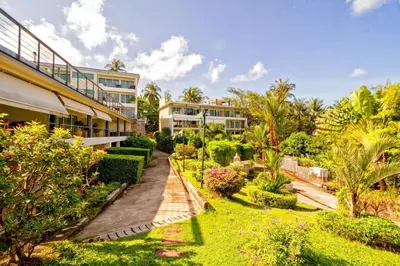 an exterior view of a resort with plants and trees at Karon Butterfly Condominium Brandnew 68m2 apartment, seaview, pool access, 500m to beach in Karon Beach