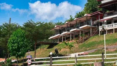a person standing in front of a building on a hill at So View Phuket Resort in Ban Sam Kong