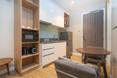 a kitchen and dining room with a table and a microwave at Pool Access Condo Bangtao Beach in Bang Tao Beach