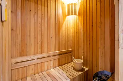 a wooden sauna with a bucket on a wooden shelf at Pool Access Condo Bangtao Beach in Bang Tao Beach