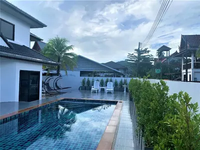 a swimming pool in the backyard of a house at Chonlada Pool Villa - 6-BR - Kamala Beach in Phuket Town