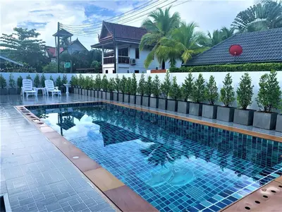 a swimming pool in front of a house at Chonlada Pool Villa - 6-BR - Kamala Beach in Phuket Town