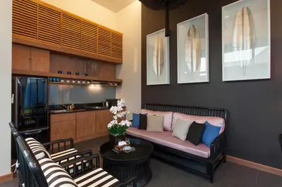 a living room with a couch and a kitchen at Wings Phuket Villa by Two Villas HOLIDAY in Bang Tao Beach