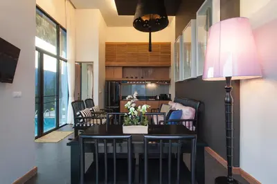a dining room with a table and chairs at Wings Phuket Villa by Two Villas HOLIDAY in Bang Tao Beach