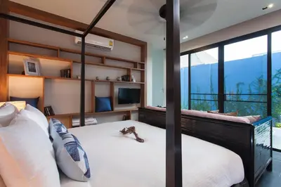 a bedroom with a large bed with a large window at Wings Phuket Villa by Two Villas HOLIDAY in Bang Tao Beach
