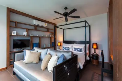 a bedroom with a large bed with pillows at Wings Phuket Villa by Two Villas HOLIDAY in Bang Tao Beach