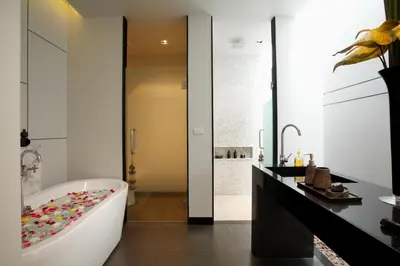 a bathroom with a white tub and a black counter at Wings Phuket Villa by Two Villas HOLIDAY in Bang Tao Beach