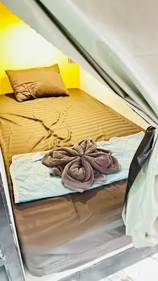 a bed in a tent with a blanket on it at Rc Guest House in Phi Phi Don