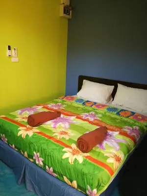 a bed with two towels on top of it at Rc Guest House in Phi Phi Don