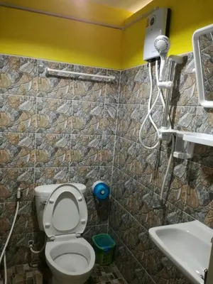 a bathroom with a toilet and a sink at Rc Guest House in Phi Phi Don