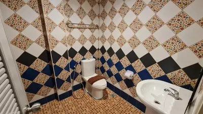 a bathroom with a toilet and a sink at Vech Guesthouse Patong in Patong Beach
