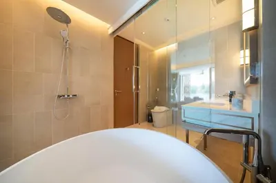 a bathroom with a white tub and a shower at Laguna Angsana Apartments Lake View in Bang Tao Beach