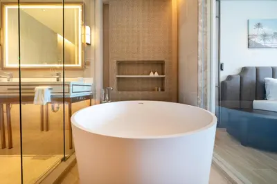a bath tub in a bathroom with a shower at Laguna Angsana Apartments Lake View in Bang Tao Beach
