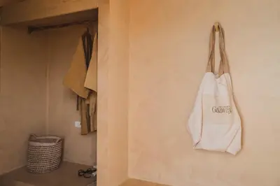 a white bag is hanging on a wall at Casa Solana Patong in Patong Beach