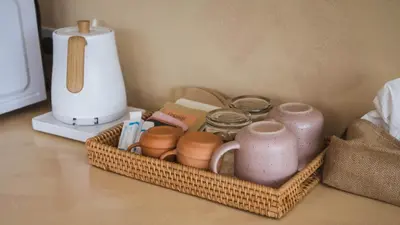 a basket filled with pots and jars on a counter at Casa Solana Patong in Patong Beach