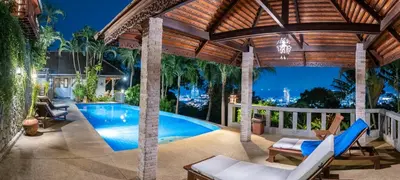 an outdoor patio with a swimming pool and a pergola at Baiyok Villa seaview and edge pool in Patong Beach
