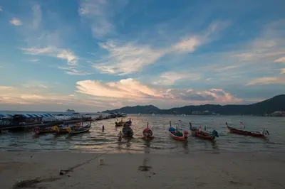 a group of boats in the water on a beach at Patong Signature Boutique Hotel in Patong Beach