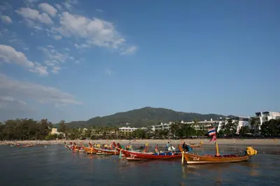 a group of boats in the water near a beach at Patong Signature Boutique Hotel in Patong Beach