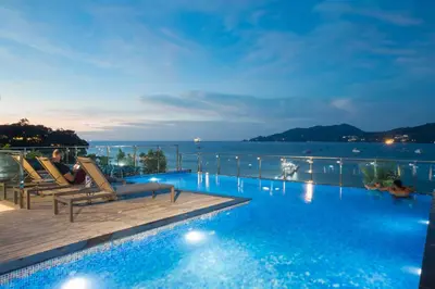 a hotel swimming pool with a view of the ocean at Patong Signature Boutique Hotel in Patong Beach