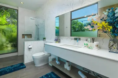 a bathroom with a sink and a toilet and a mirror at Villa Mimosa 1, Luxury 4BR with Private Pool/Rawai in Phuket Town