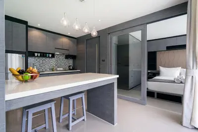 a kitchen with a counter with a bowl of fruit on it at Tropics Kamala Deluxe Pool View Apartment CTG P402 in Kamala Beach