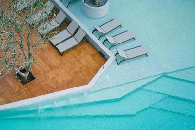 an overhead view of a pool with tables and chairs at Tropics Kamala Deluxe Pool View Apartment CTG P402 in Kamala Beach