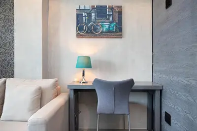 a living room with a desk with a chair and a lamp at tropics Kamala Deluxe Pool View Apartment CTG P602 in Kamala Beach