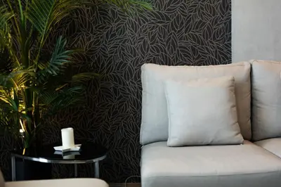 a living room with a white couch and a plant at tropics Kamala Deluxe Pool View Apartment CTG P602 in Kamala Beach