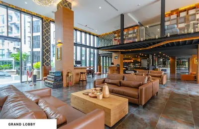 a living room with leather furniture and a fireplace at tropics Kamala Deluxe Pool View Apartment CTG P602 in Kamala Beach
