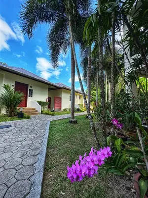 a house with pink flowers in the yard at Serenity Lakeside Resort in Kathu