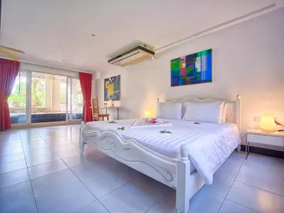 a bedroom with a large white bed in a room at Serenity Lakeside Resort in Kathu