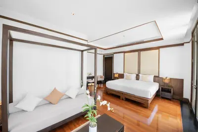 a bedroom with two beds and a large window at Villa Aye in Kamala Beach