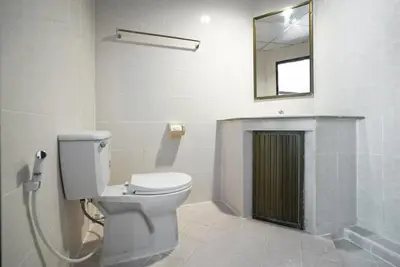 a bathroom with a toilet and a mirror at Tri's Miracle Kata Beach Side in Kata Beach