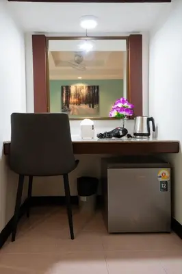 a desk in a room with a chair and a mirror at Tri's Miracle Kata Beach Side in Kata Beach